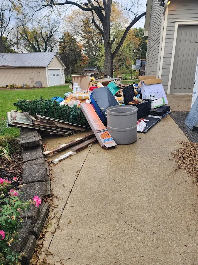 Dumpster being loaded with debris for 3 Yard Dumpster Rental in Tega Cay